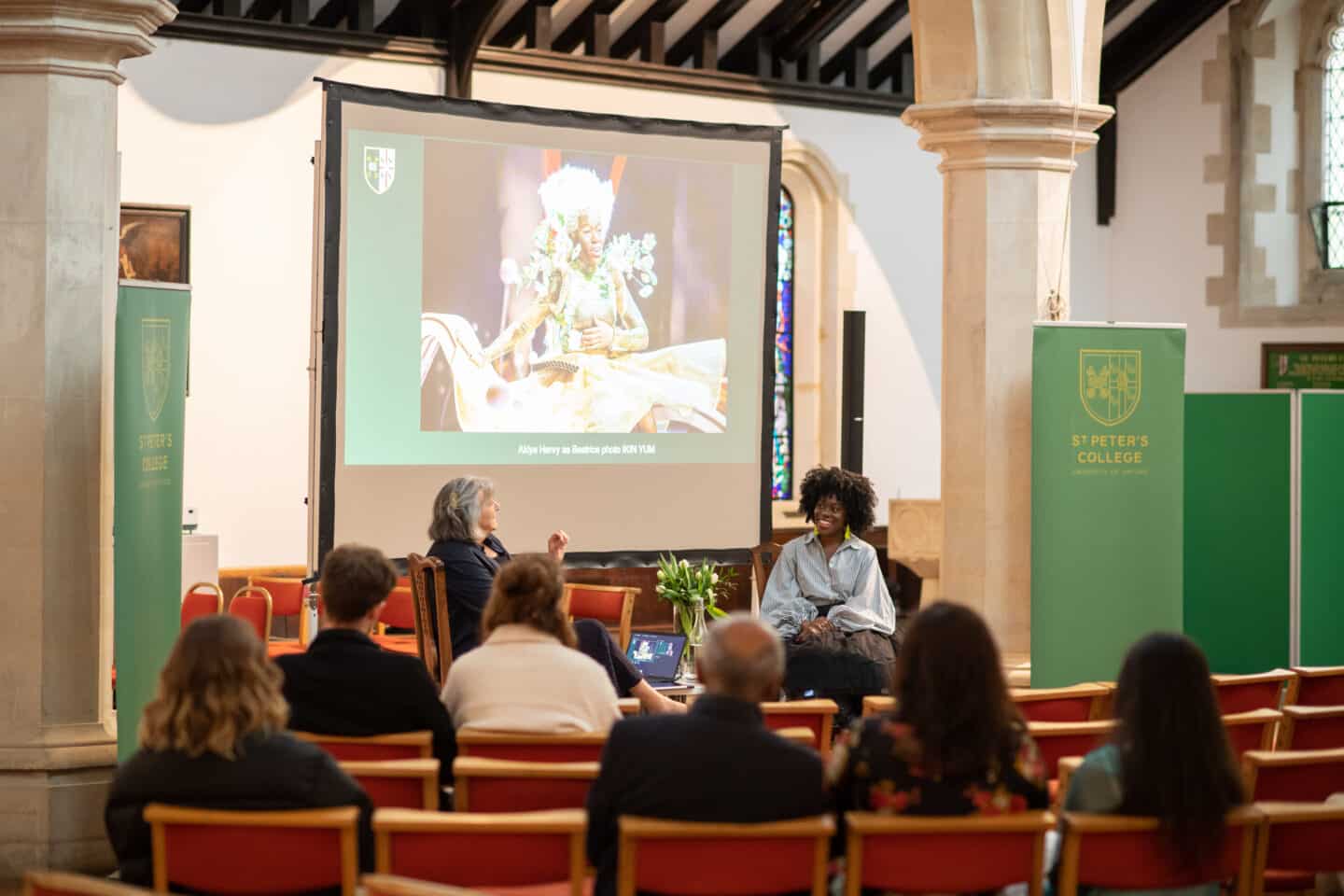 Two women speaking at a public event