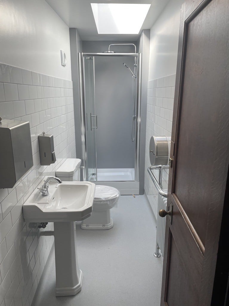 Modern bathroom with sink, toilet and shower cubicle