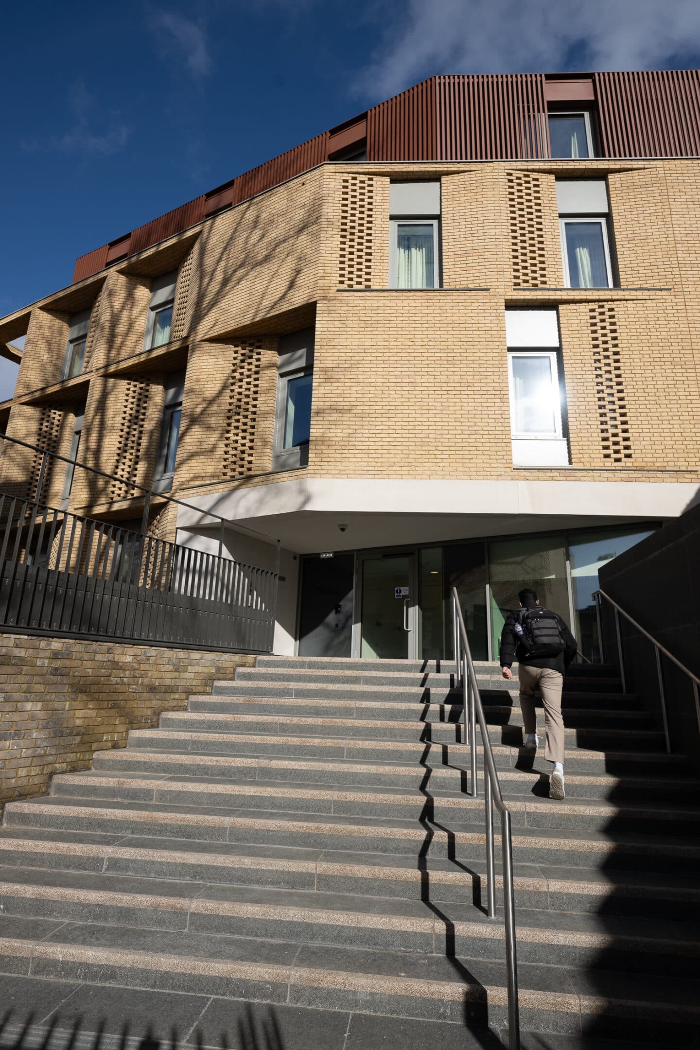 A staircase leading to a large brick building