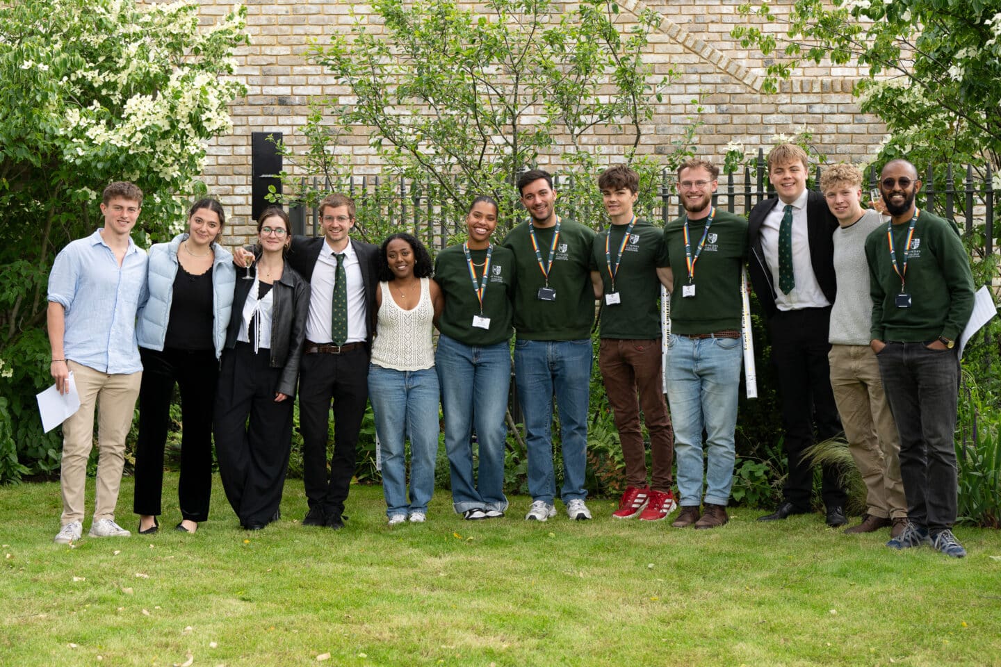 12 students standing close together and smiling