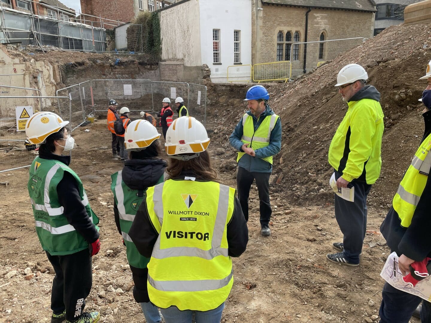 image of a group of visitors at an archaeological and building site