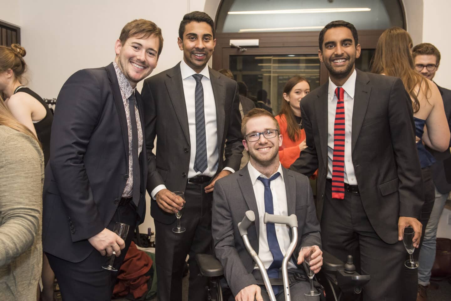 four people in formal wear smiling