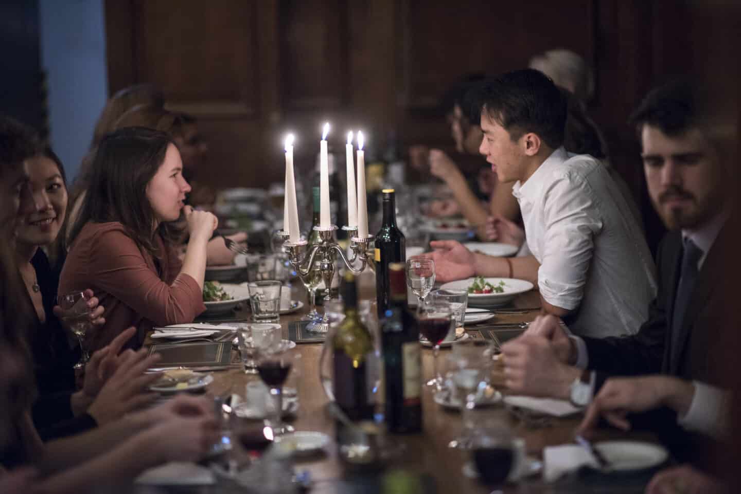 A formal dinner with a large group of students in an Oxford dining hall
