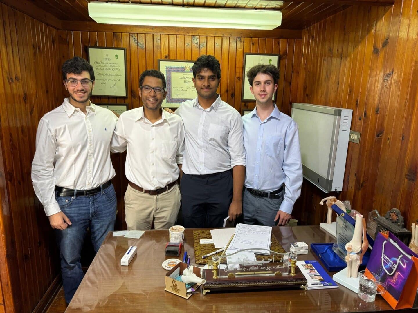 Four men standing in an office