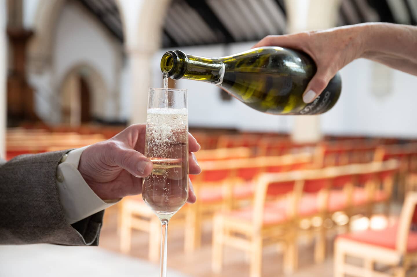 a champagne flute being filled with wine