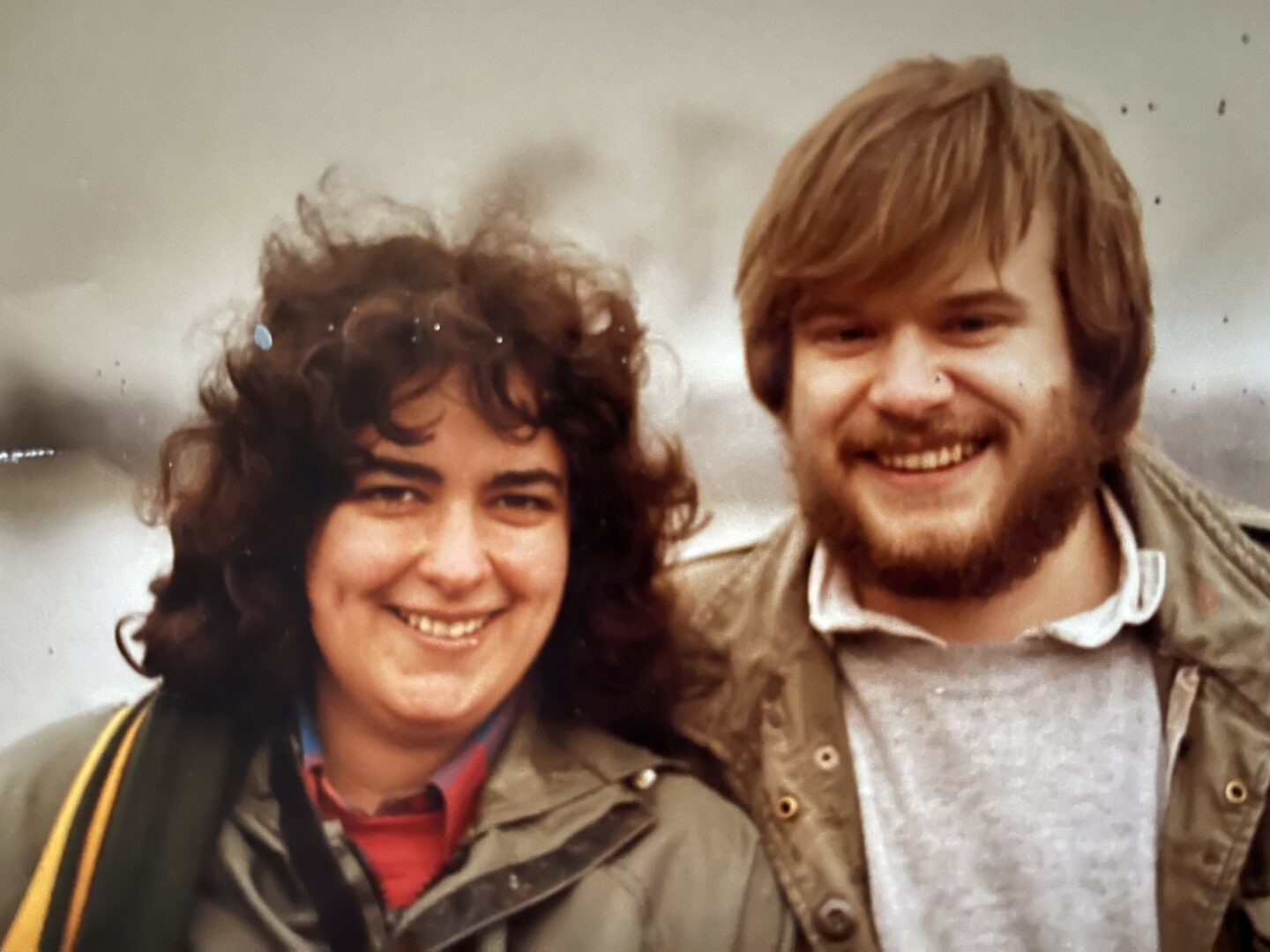 A smiling couple standing outdoors