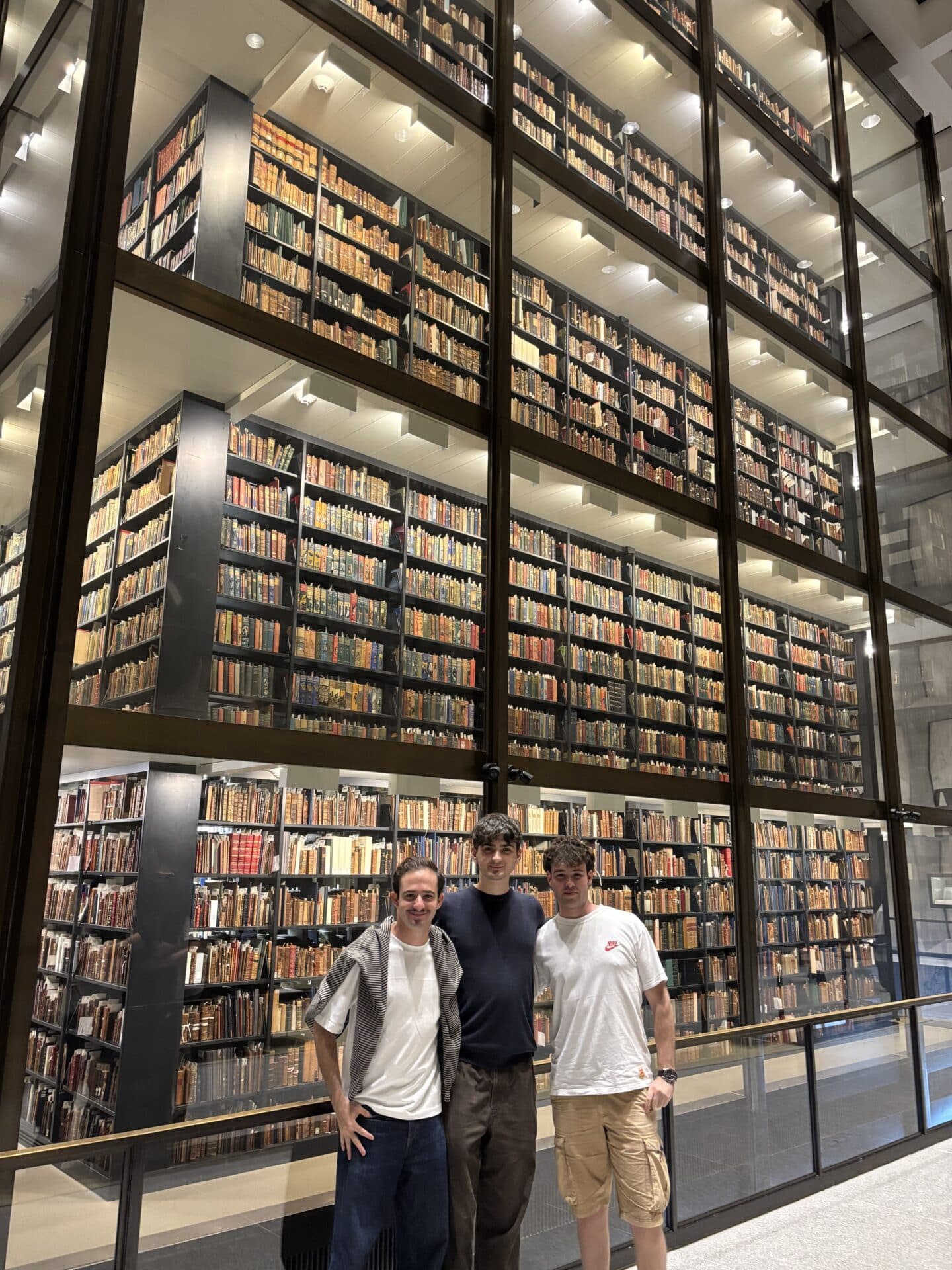 Three young people in a library