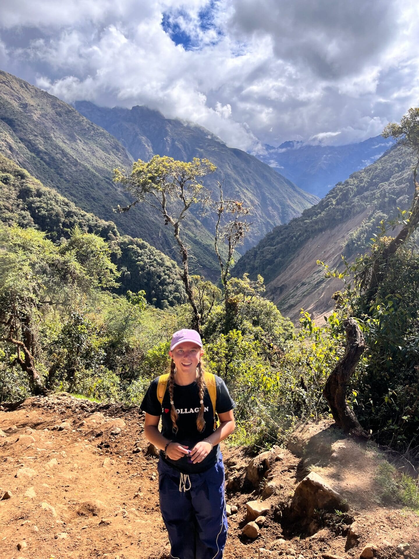 A young person standing in a mountainous landscape