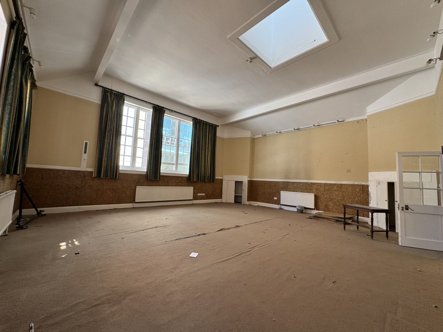 A dilapidated room with large windows