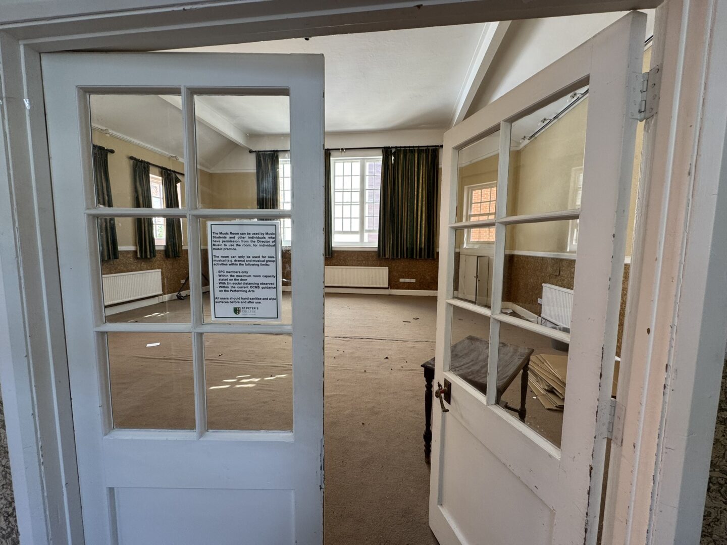 A dilapidated room with large windows