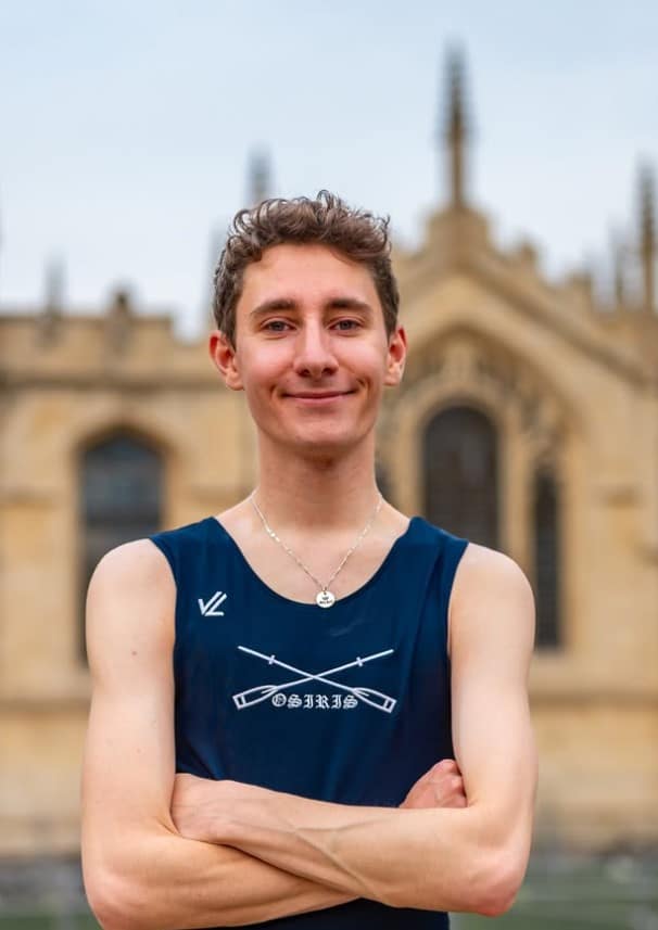 A young man standing with his arms crossed
