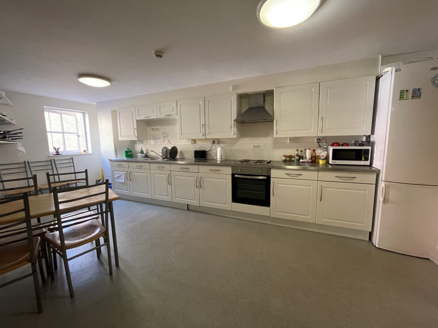 Kitchen with worksurfaces, cupboard, hob, sink and table and chairs