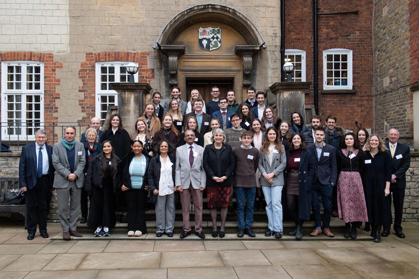 A group of Malde scholars from the past ten years gathered outside of the College Dining Hall