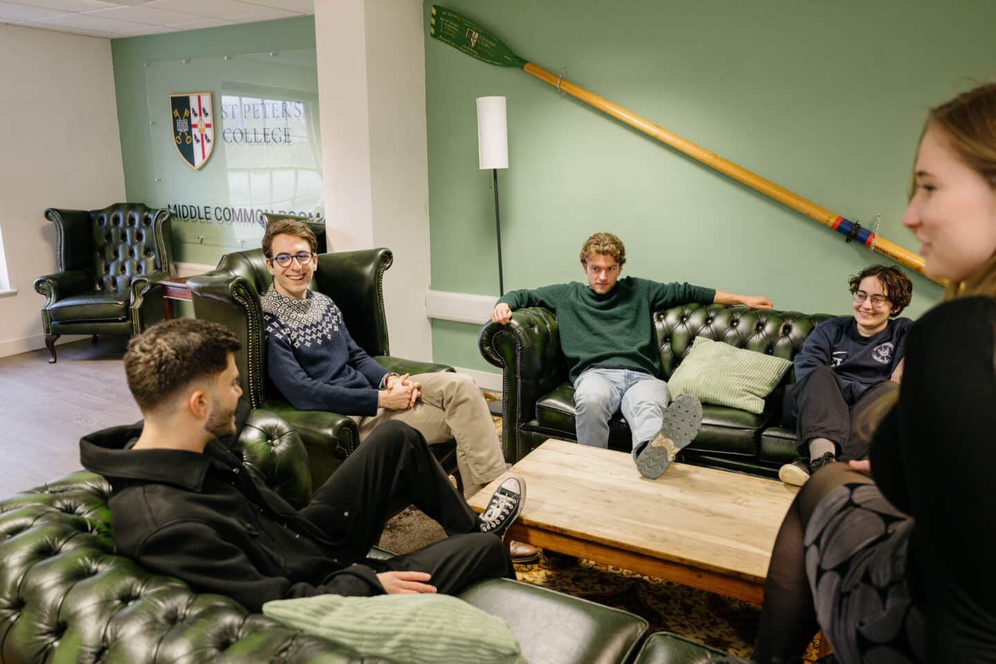 A group of people sat on sofas and armchairs.