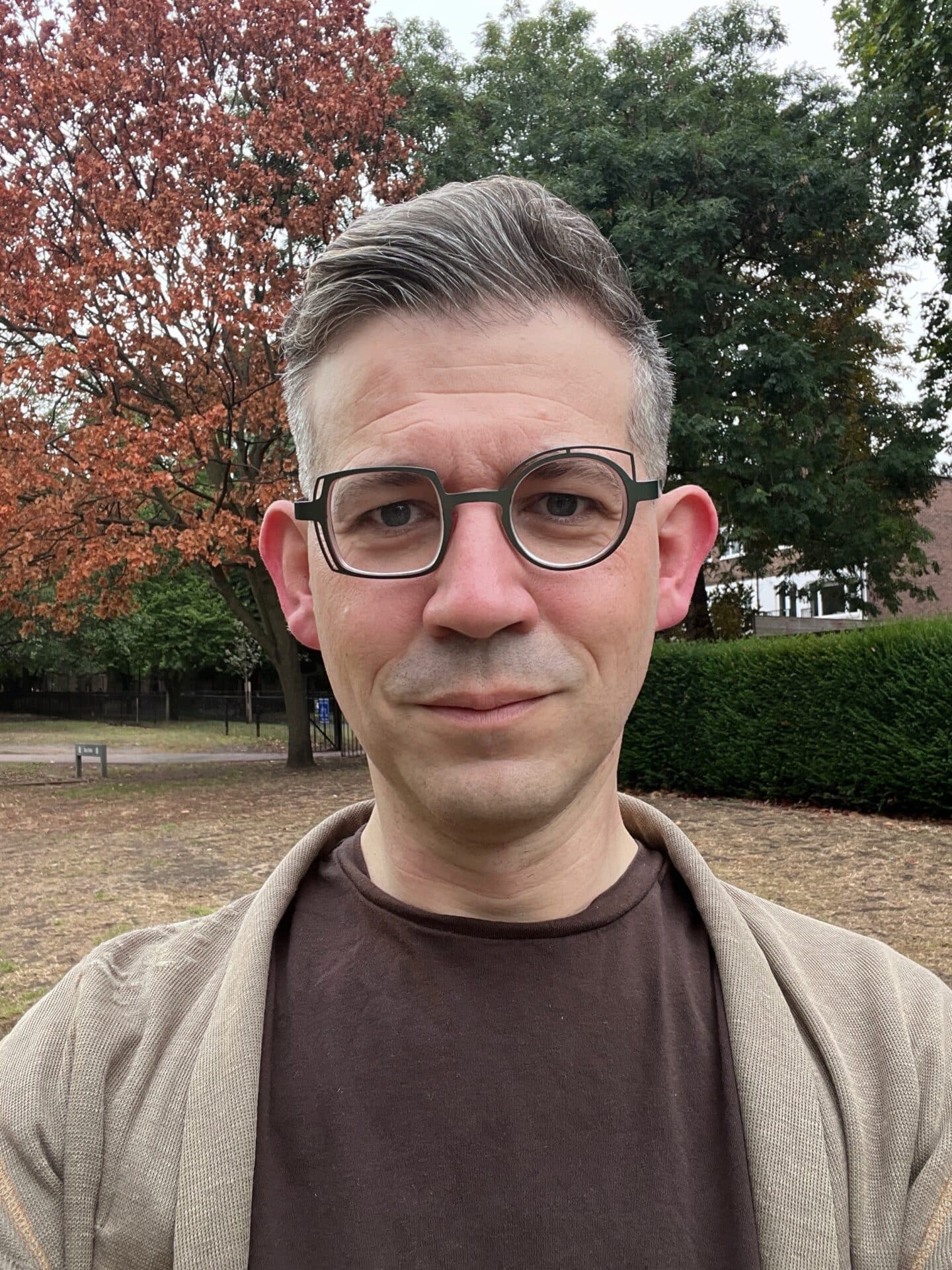 A headshot of a person wearing glasses