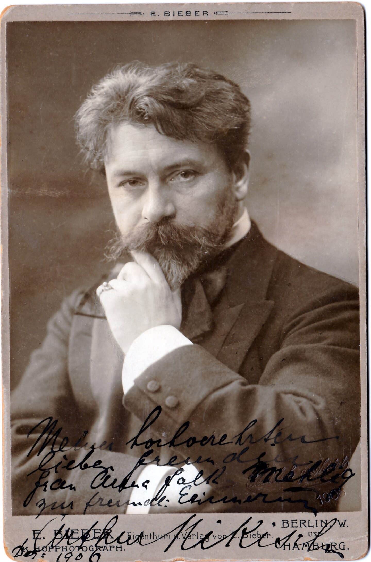 An old photograph - an early 20th-century headshot of a man seated