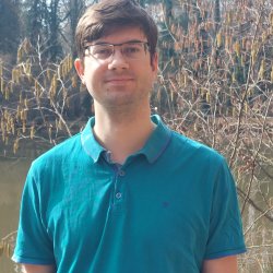 A person wearing a blue shirt and glasses