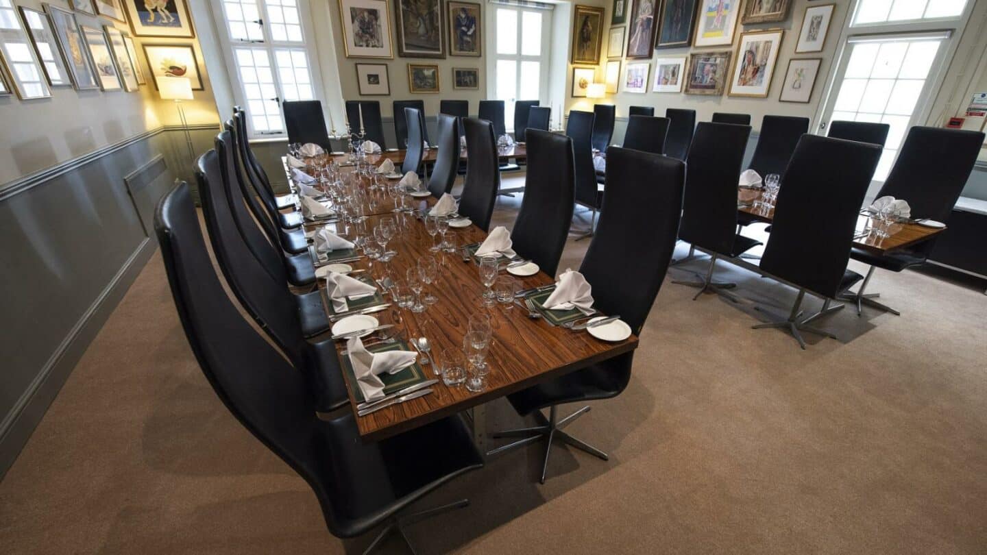 A dining room with a table set for a formal meal