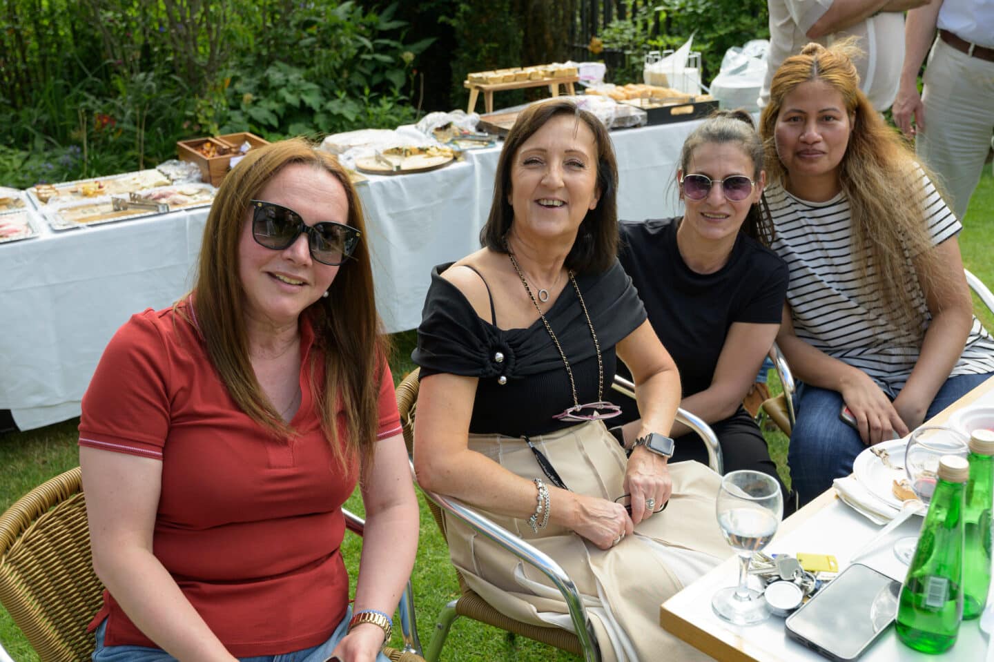 four women at a garden party