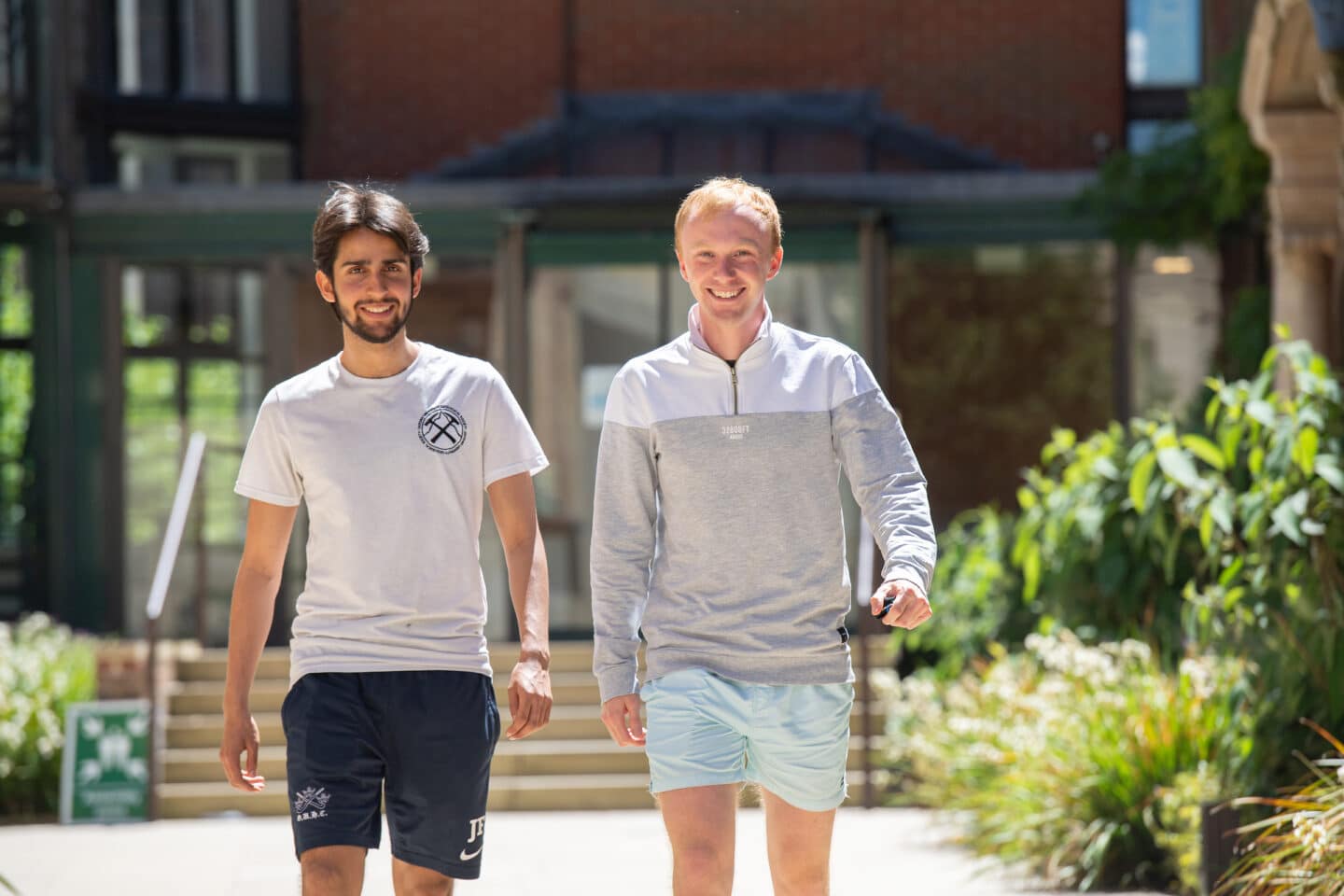 two students walking together outdoors