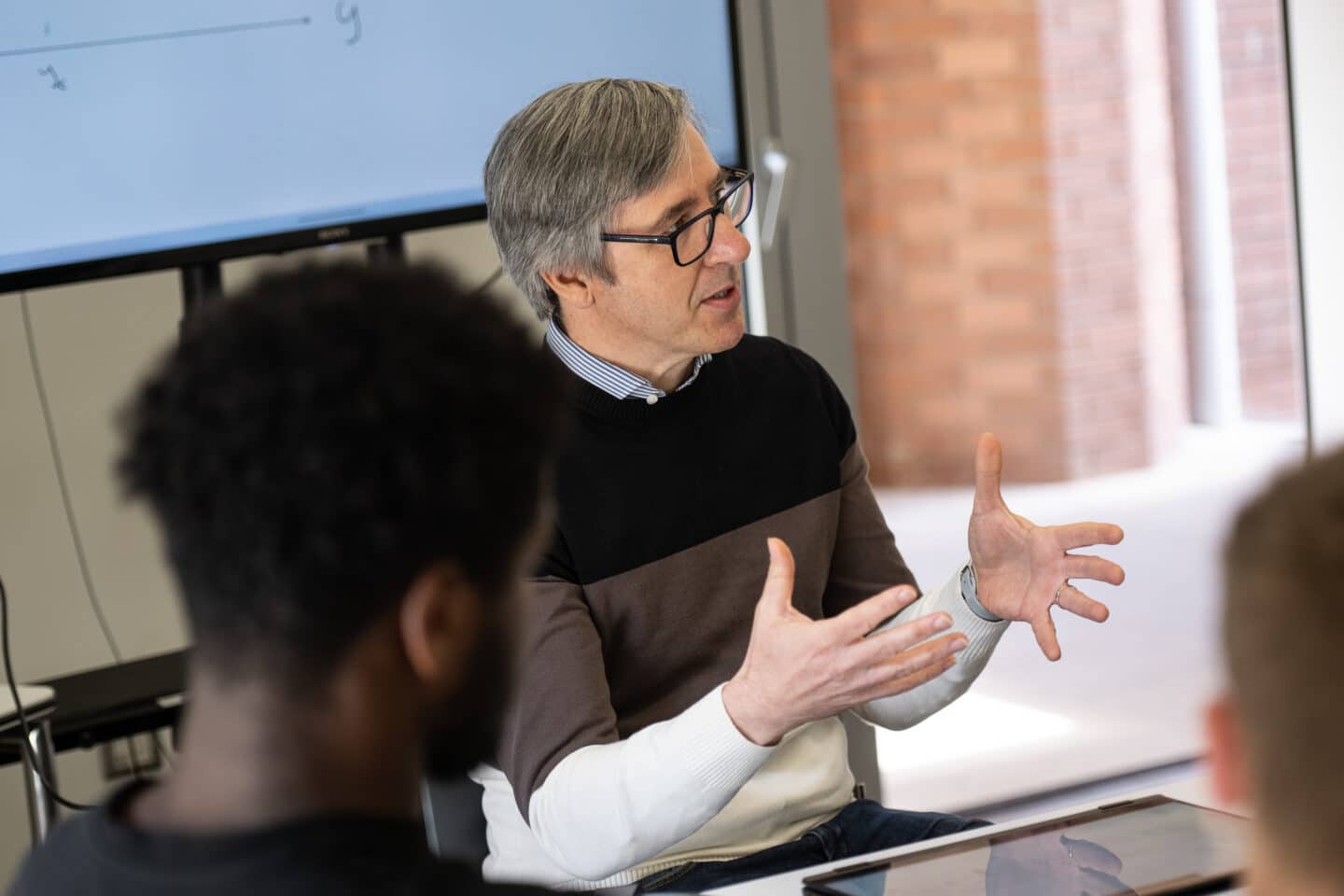 A person speaking in a classroom setting