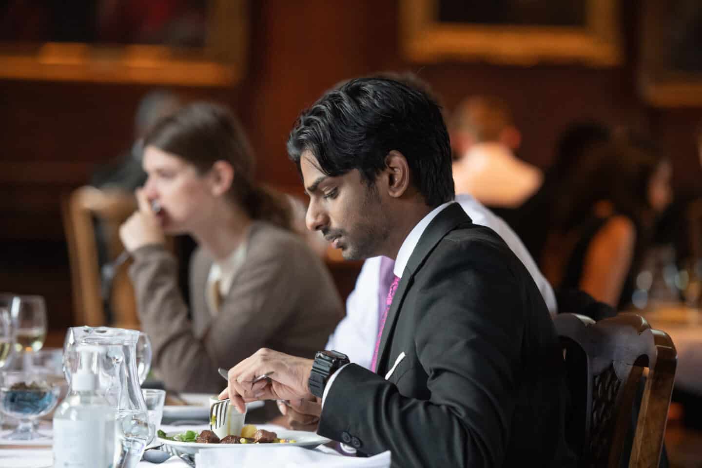 A student eating a formal dinner