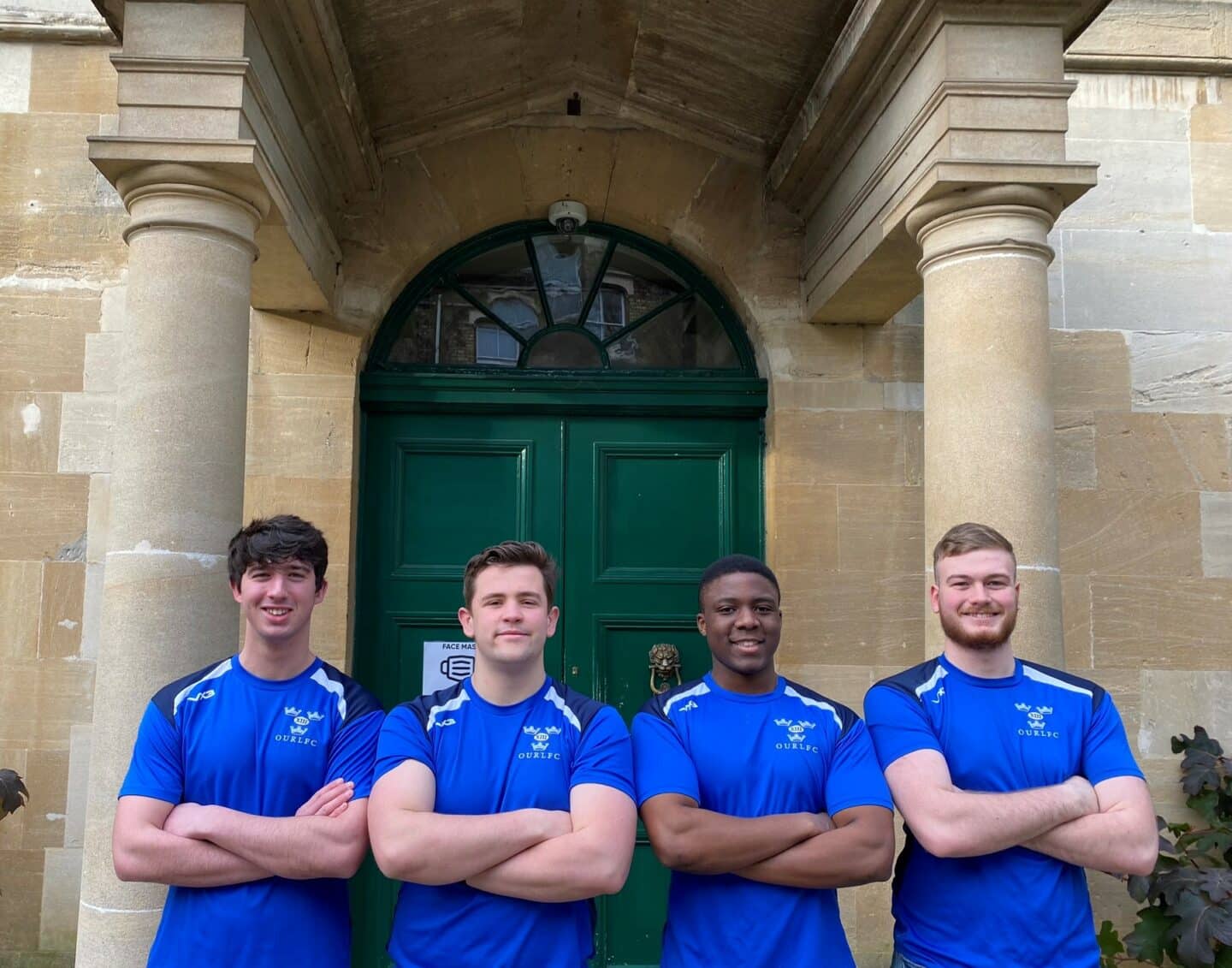 Four St Peter's College students standing outside the lodge