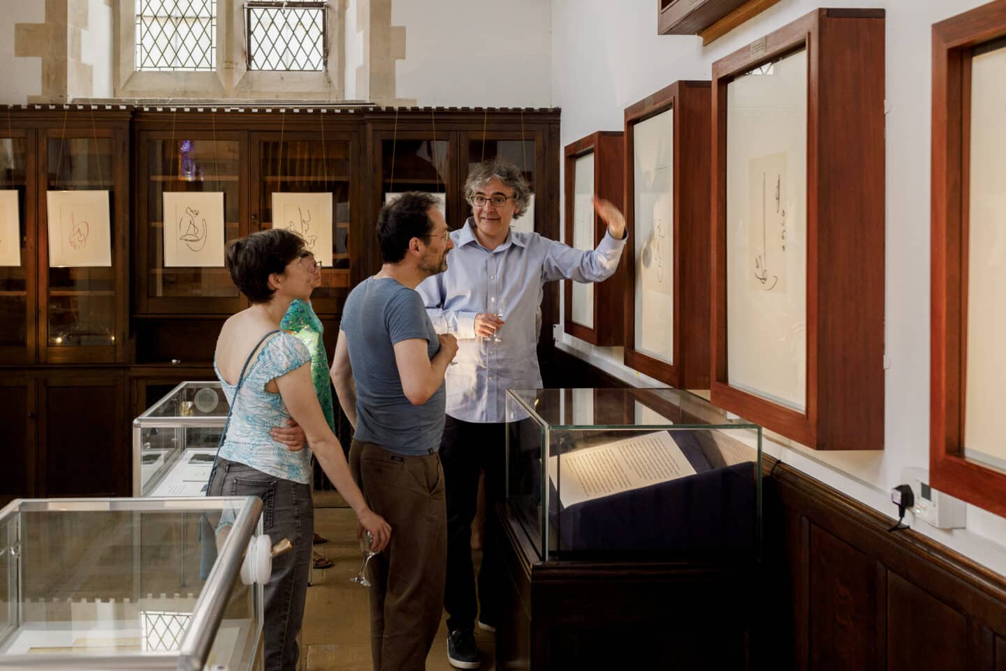 People looking at and discussing an art exhibit