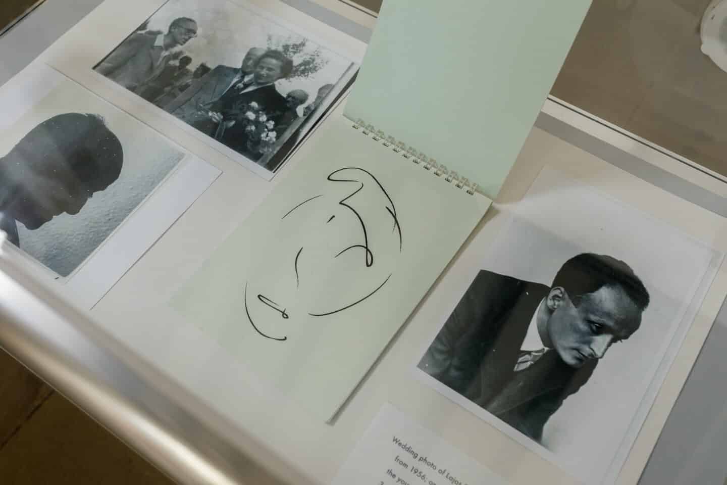 A detail of an art exhibit display with photos and an a drawing