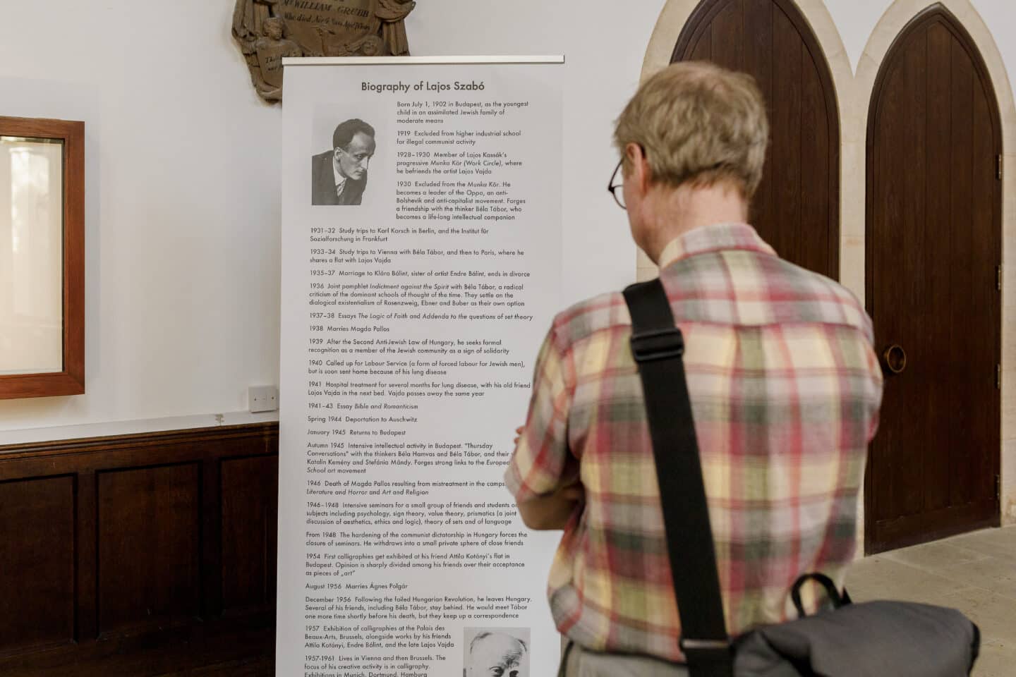 A man reading informational text at an art exhibit