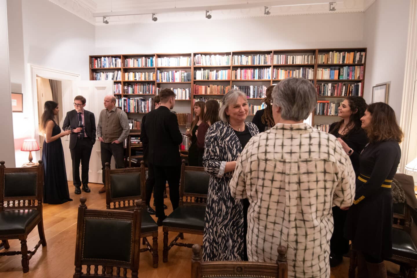 Audience and performers chat in Canal House after the recital is finished