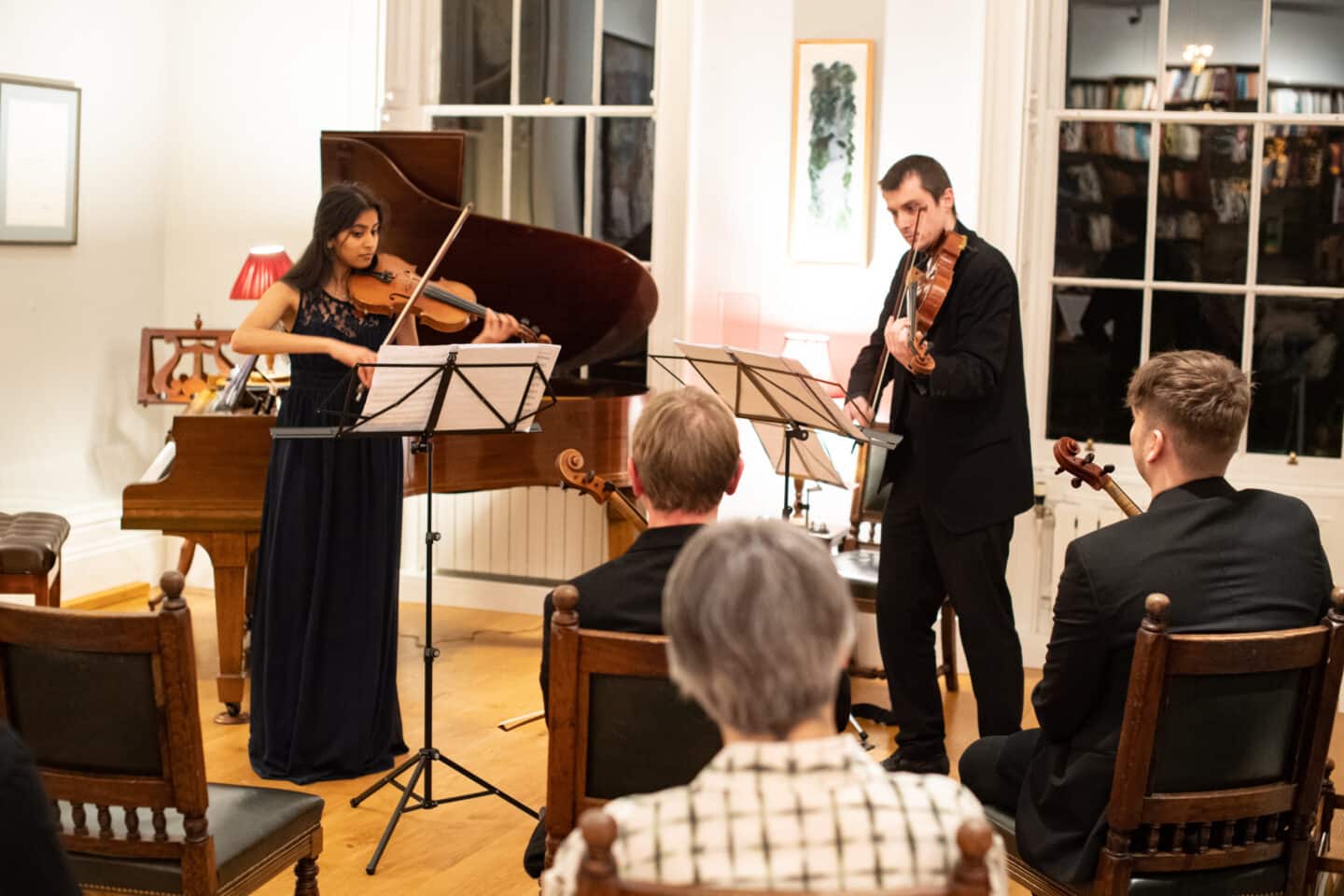 Two musicians performing at a recital