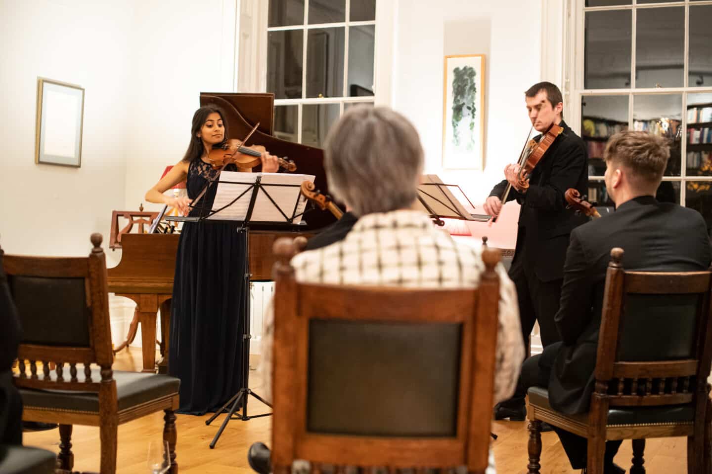 First-year Maanya Patel plays a string duet with Peter Mallinson