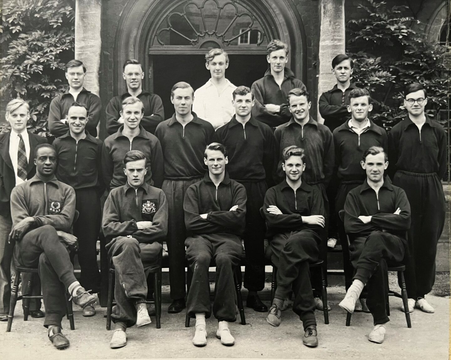 A group of athletes seated and standing together.