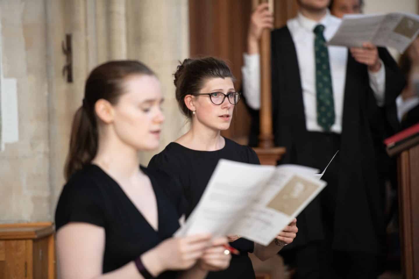 two people singing in a choir