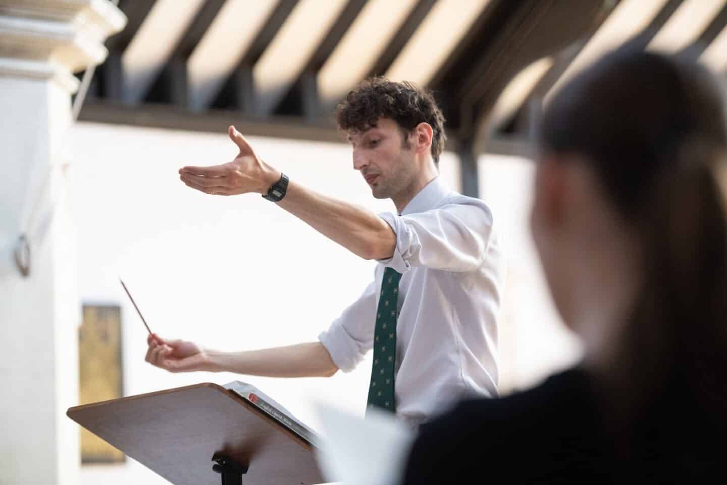 a choir director conducting a practice