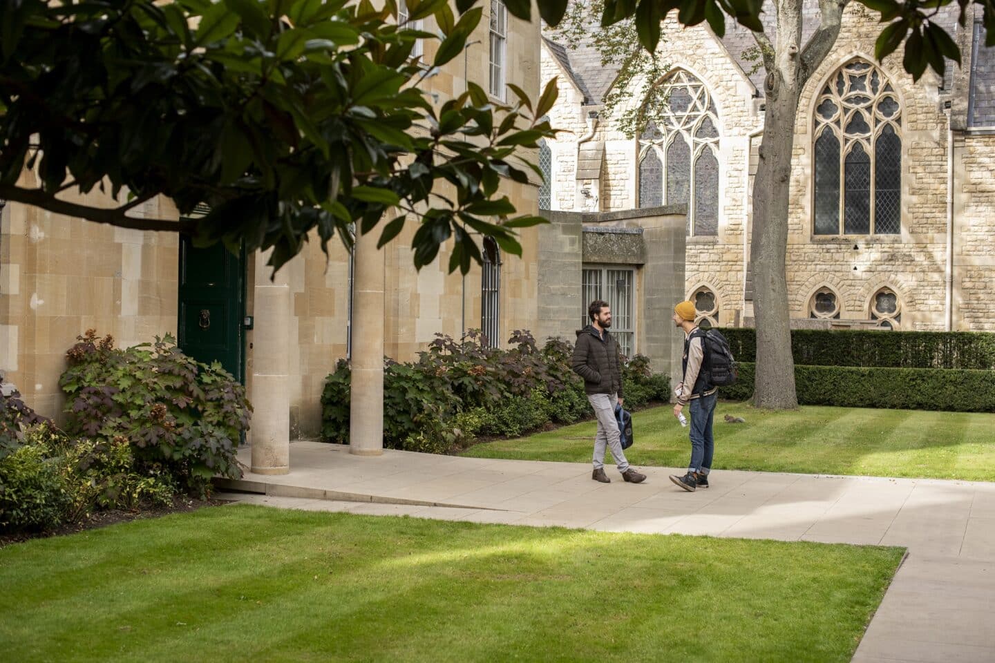 two people standing outside the St Peter's College lodge