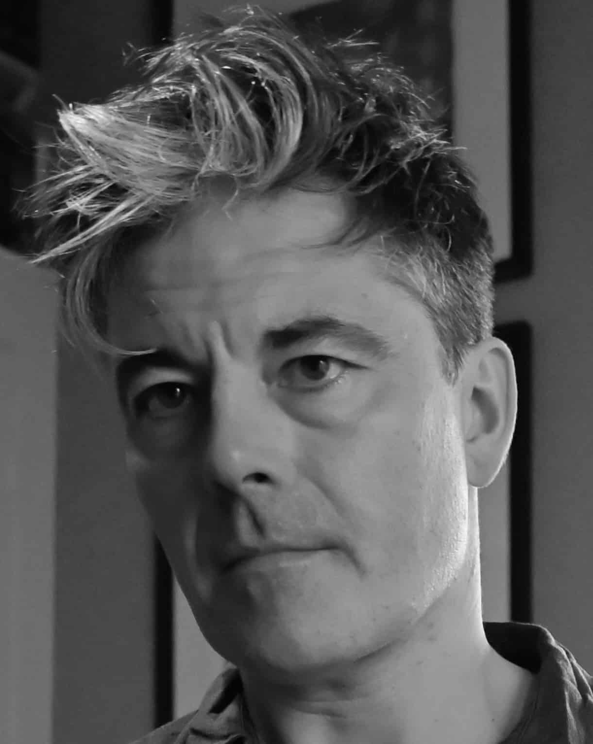 A black and white headshot of a man