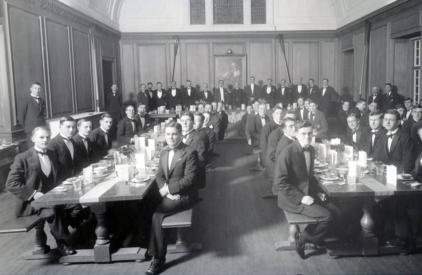 Early 20th century photograph of young men in a large dining hall