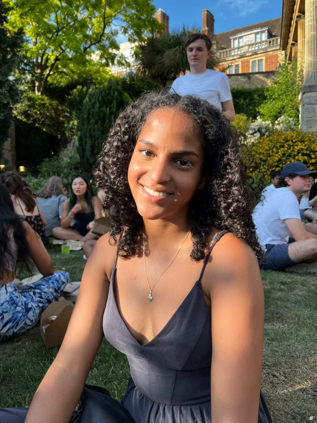 A seated smiling student