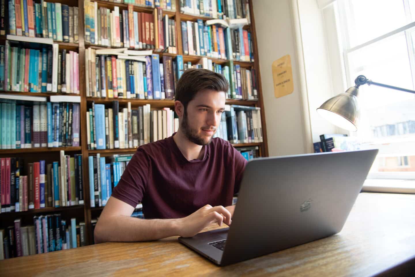 a student using a laptop in a library