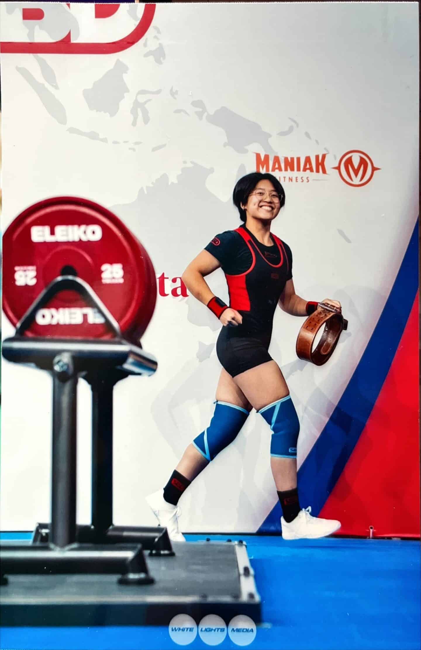 A woman wearing powerlifting gear