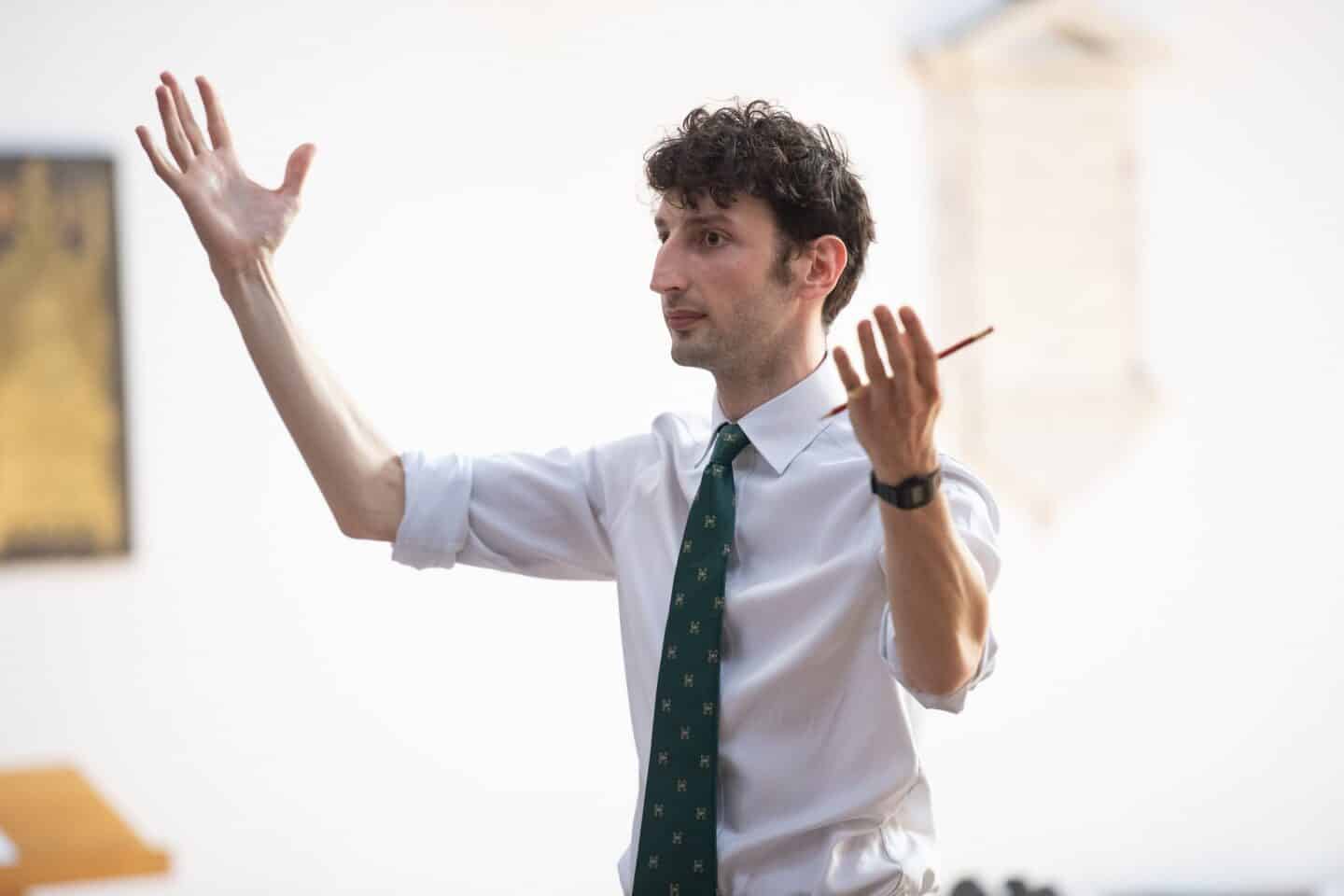 an image of a man directing a choir