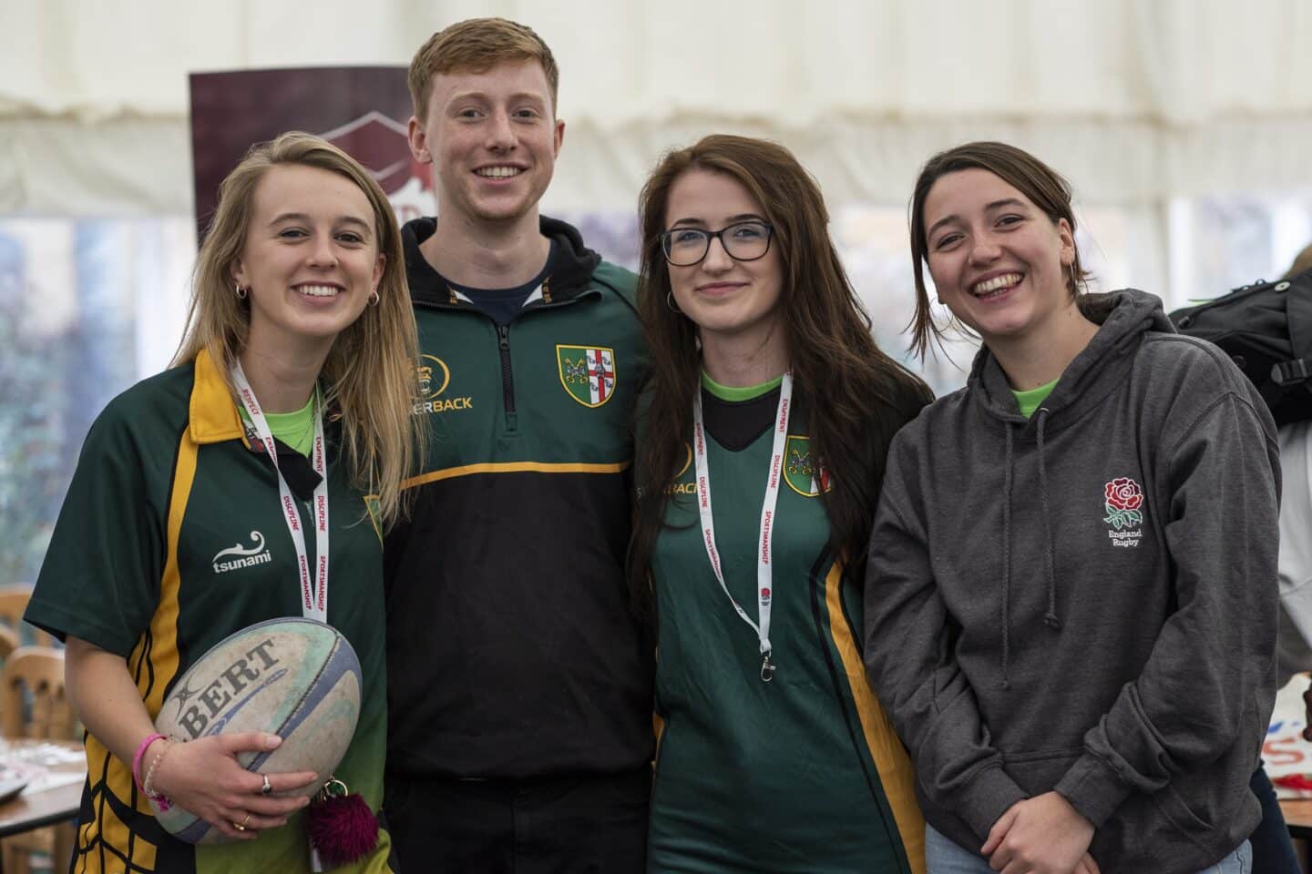 four athletes smiling