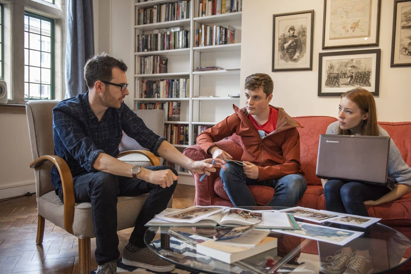 three people sitting in an office for a meeting