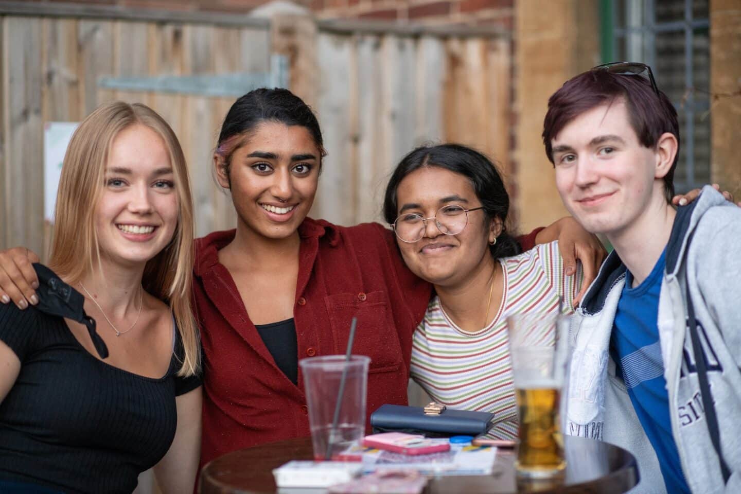 four people posing and smiling