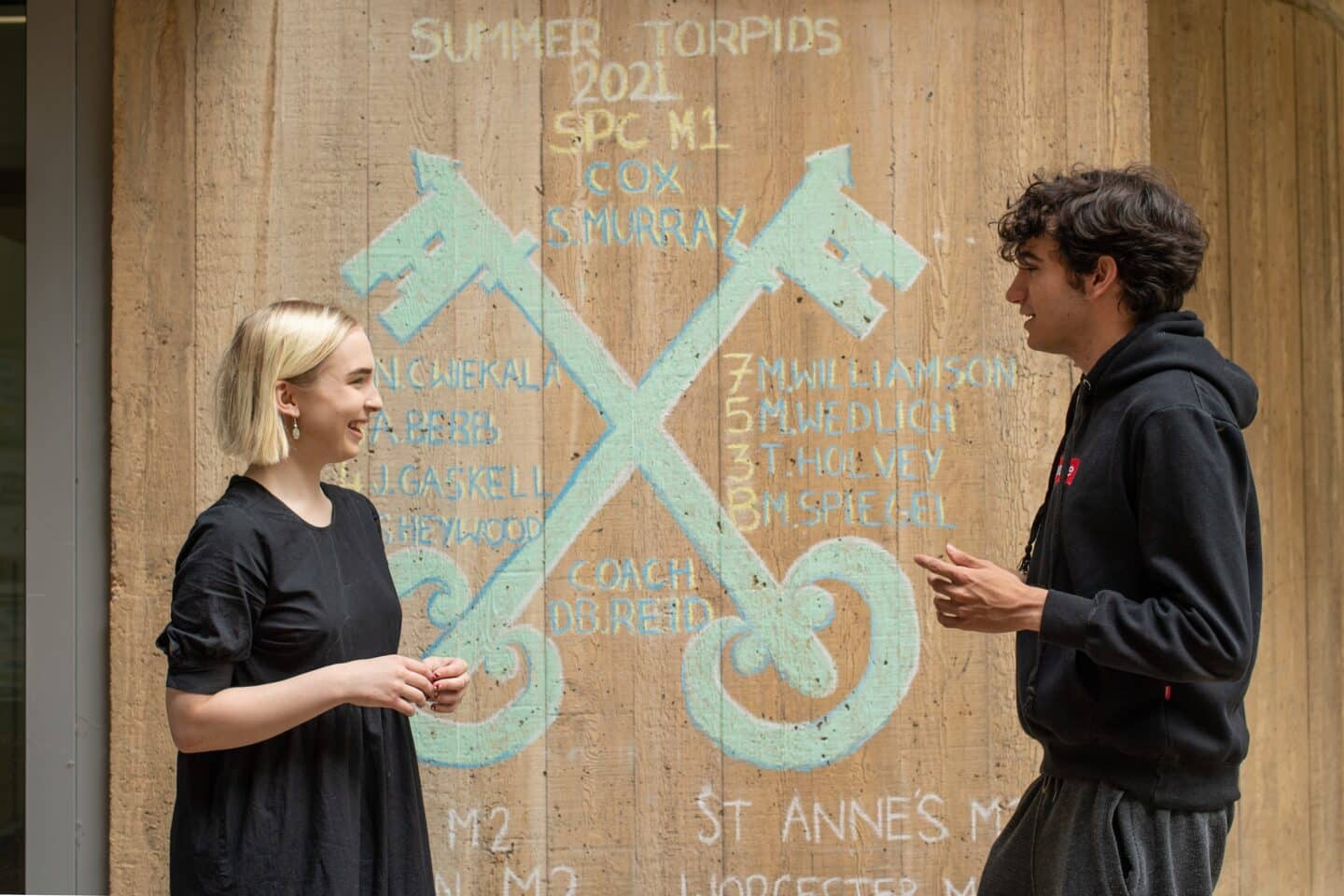 two people standing outside a building