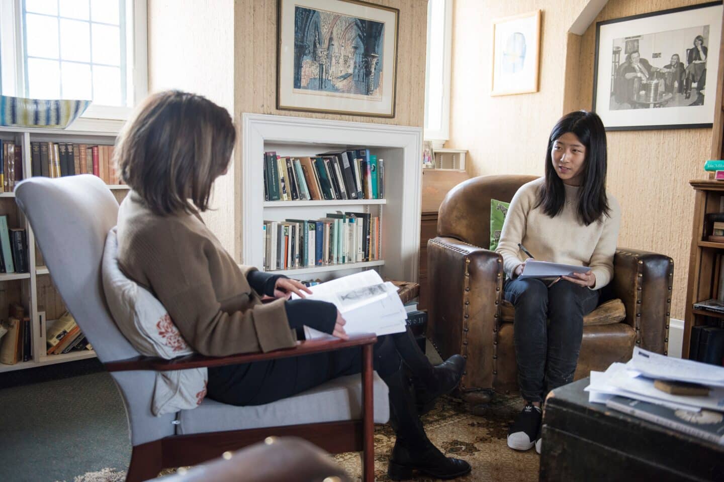 two people sitting in an office and having a meeting