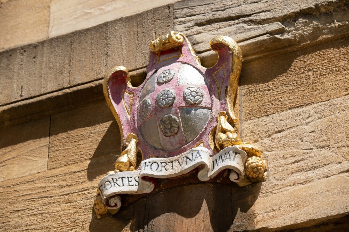 building detail showing a crest with Latin words